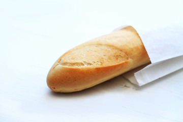 french baguettes, loaves on a light wooden background