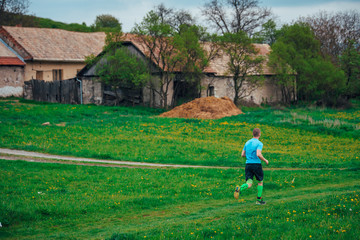 Man athlete run in rural spring farmland