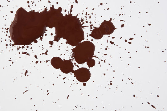 brown chocolate splatter drops on white background top view