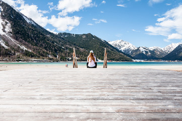 Woman sitting on jetty