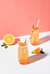 Cold and refreshing orange punch cocktail with orange slice on color background. summer drink.