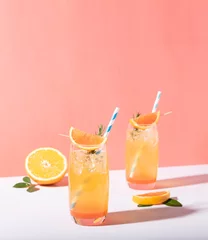 Foto op Plexiglas Cold and refreshing orange punch cocktail with orange slice on color background. summer drink. © NaMong Productions