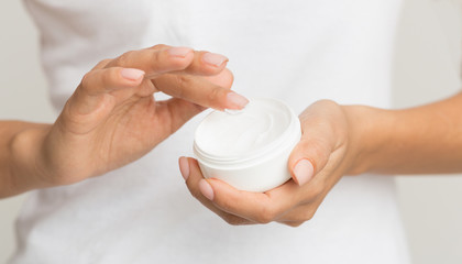 Woman using moisturizing cream for clean and soft skin