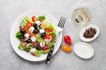 Greek salad plate and white wine