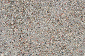gray  wall decorated with colorful pebbles background texture