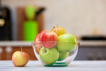 Fresh organic apples on a wooden table in a plate. Natural light. Selective focus