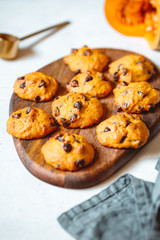 Pumpkin cookies with chocolate chips made from cake mix on a wooden tray.
