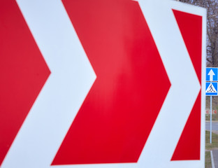 road signs showing the direction of movement, pedestrian crossing, bright colors