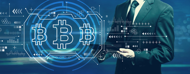 Bitcoin with businessman holding a tablet computer