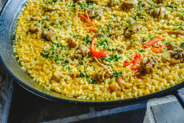 Rice and rabbit, typical dish of the gastronomy of the region of Murcia, Spain, cooked in a paella pan.