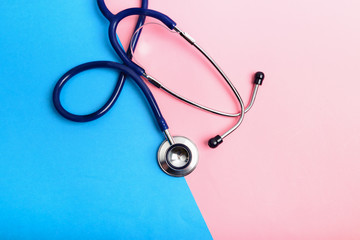 Stethoscope between blue and red areas, the concept of healthy and unhealthy lifestyle