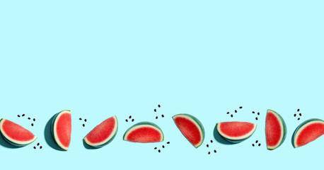 Sliced watermelons arranged on a blue background