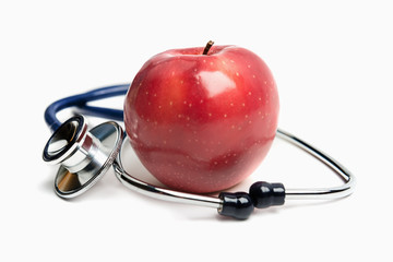 Apple and stethoscope on white background