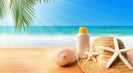 Sunblock with straw hat on the tropical beach and sunshine