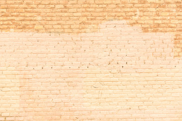 Texture of a brick wall painted in orange tones, ideal for background with space for free text.