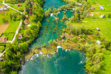 Croatian countryside landscape, beautiful green Mreznica river from air, panoramic view of Belavici village and waterfalls in spring, popular tourist destination