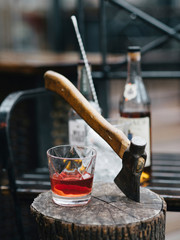 Cranberry cocktail and some bottles with liquor on the background