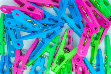 A pile of plastic colorful clothespins