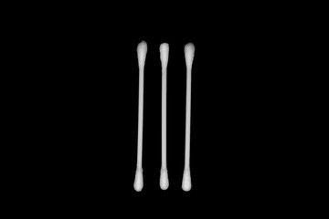 White cotton buds isolated on black background