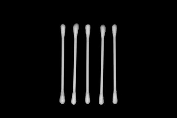 White cotton buds isolated on black background