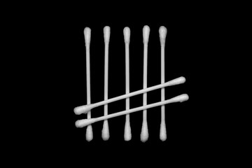 White cotton buds isolated on black background