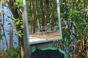 glass of red wine in mirror