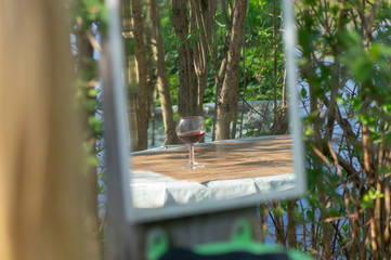 glass of red wine in mirror