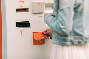 Tourist woman buys tickets for transport in Georgia. modern street machine for purchase of tickets for bus