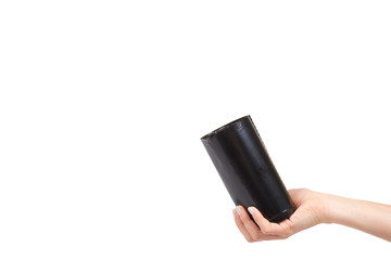 hand with roll of black plastic garbage bags for trash
