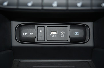12V socket, wireless mobile phone charger, USB port, AUX port on car dashboard