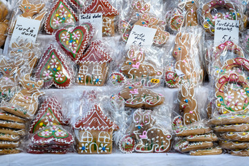 Different types of gingerbread with labels written in Romanian, on display at a food market