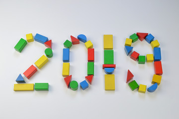 number of the year 2019 written with colorful yellow, green, red and blue toy wooden blocks