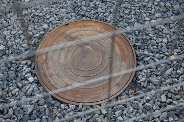 manhole cover on the rubble, repair work on the road