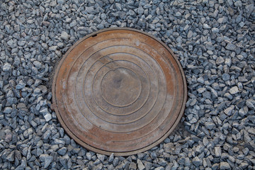 manhole cover on the rubble, repair work on the road