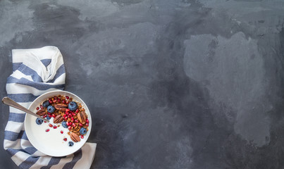Granola, muesli with pomegranate seeds, blueberries and yogurt