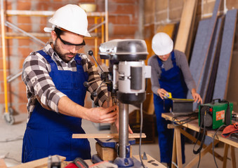 Man is worker behind drilling machine