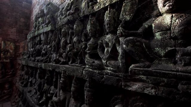 Close view of amazingly detailed stone carvings on the wall of the Terrrace of the Leper King. It is located in the northwest corner of the Royal Square of Angkor Thom, Cambodia.