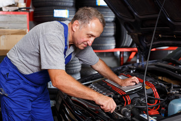 Fototapeta na wymiar Mechanic engaged in car repair