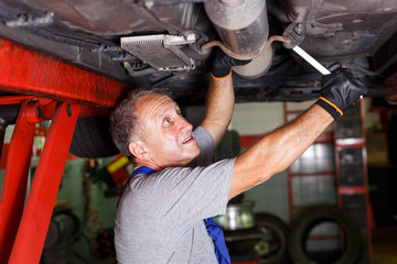 Fototapeta na wymiar Mechanic engaged in car repair
