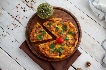 Homemade italian pizza with pesto sauce