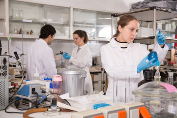 Team of young chemists working in laboratory