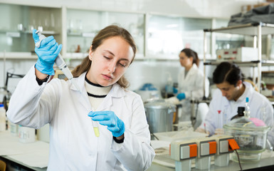 Female chemist mixing reagents