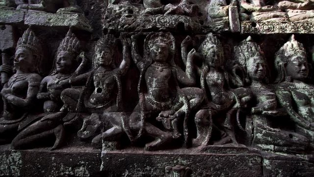 Close sliding view of stone carvings on the wall of the Terrrace of the Leper King. It is located in the northwest corner of the Royal Square of Angkor Thom, Cambodia.