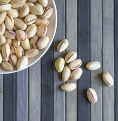 Healthy food  for background image close up pistachios nuts. Texture on top view Nuts pistachio on the cup plate