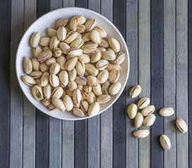 Healthy food  for background image close up pistachios nuts. Texture on top view Nuts pistachio on the cup plate
