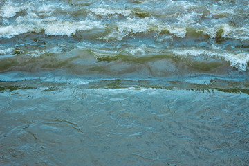 Background of a blue rough sea with white foam and waves that crush each other – Natural powerful and dangerous phenomenon of water during a storm