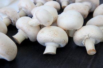 fresh mushrooms on wooden black background