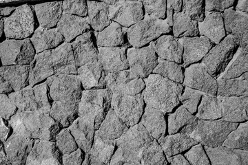 fragment of gray stone wall, decorative decoration of the building facade