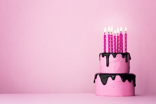 Pink birthday cake with candles