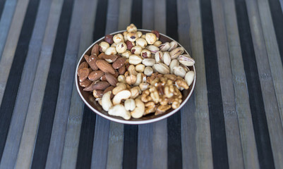 Healthy food. Nuts mix assortment on stone texture top view. Collection of different legumes for background image close up nuts, pistachios, almond, cashew nuts, peanut, walnut. image